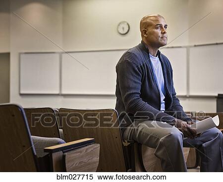 Male professor sitting in empty lecture hall View Large Photo Image Stock Photography - Male professor sitting in empty lecture hall. Fotosearch