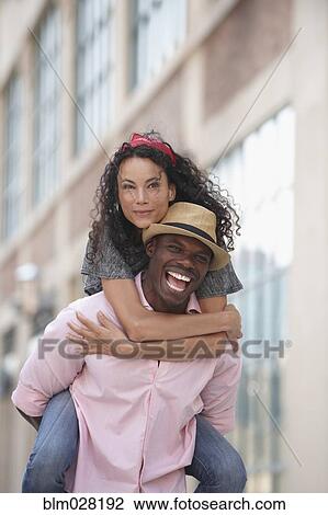 Man carrying girlfriend piggyback View Large Photo Image Stock Image - Man carrying girlfriend piggyback. Fotosearch