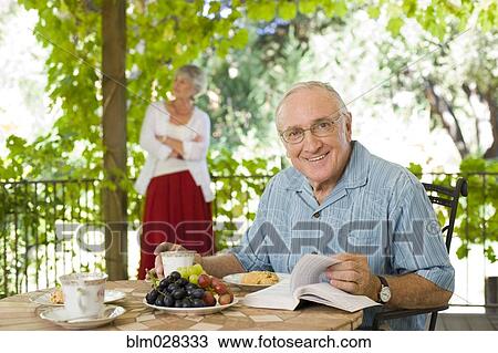 Man having breakfast outdoors View Large Photo Image Stock Image - Man having breakfast outdoors. Fotosearch