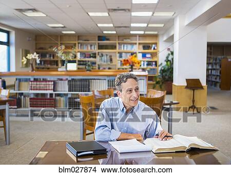 Man reading in library View Large Photo Image Picture - Man reading in library. Fotosearch
