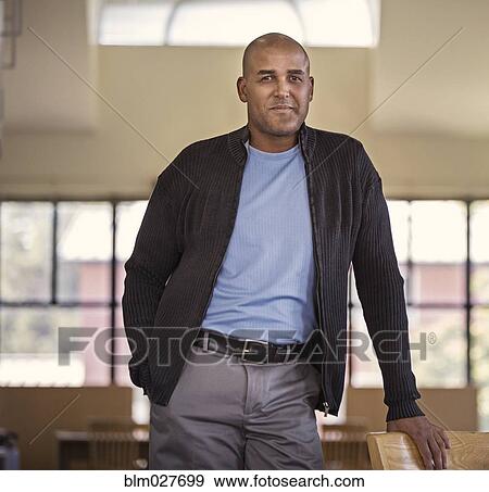 Stock Photo - Man smiling with hand in pocket. Fotosearch