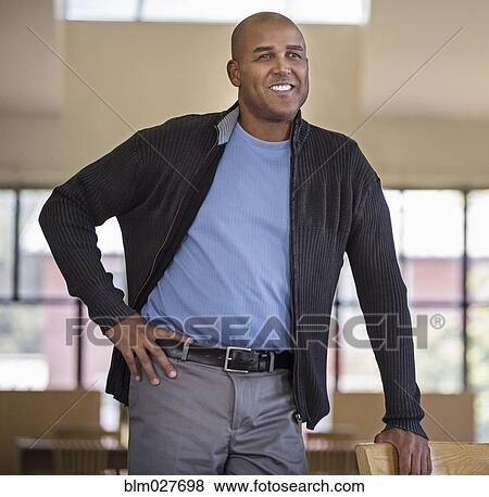 Man smiling with hand on hip View Large Photo Image Stock Photo - Man smiling with hand on hip. Fotosearch