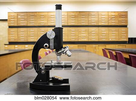 Microscope on desk of empty science classroom View Large Photo Image Picture - Microscope on desk of empty science classroom. Fotosearch