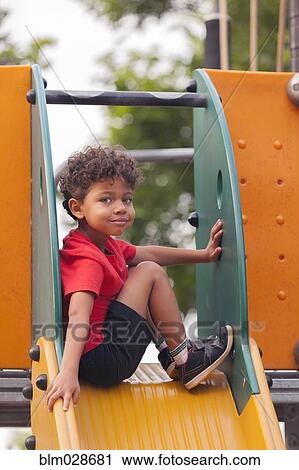 Mixed race boy on playground slide View Large Photo Image Stock Image - Mixed race boy on playground slide. Fotosearch