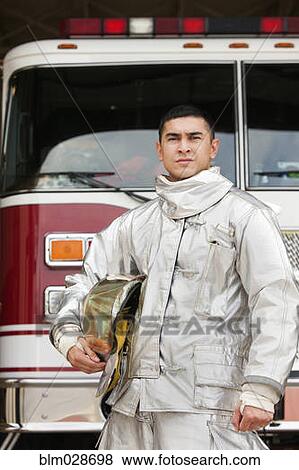 Stock Photo - Mixed race firefighter wearing protective gear. Fotosearch