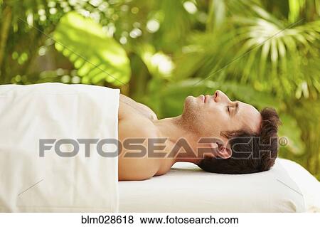 Mixed race man laying on massage table outdoors View Large Photo Image Stock Photo - Mixed race man laying on massage table outdoors. Fotosearch