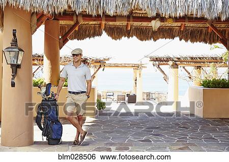 Mixed race man with golf clubs at hotel View Large Photo Image Stock Photograph - Mixed race man with golf clubs at hotel. Fotosearch