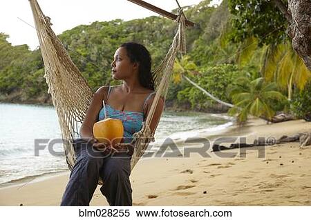 Mixed race woman relaxing in hammock on beach View Large Photo Image Stock Photography - Mixed race woman relaxing in hammock on beach. Fotosearch