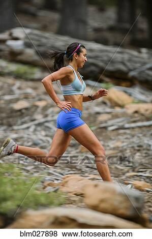 Mixed race woman running in woods View Large Photo Image Stock Photo - Mixed race woman running in woods. Fotosearch