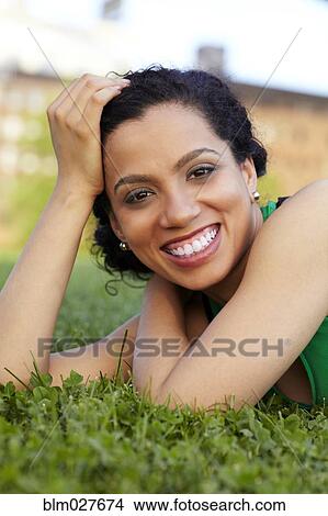 Mixed race woman smiling in grass View Large Photo Image Picture - Mixed race woman smiling in grass. Fotosearch