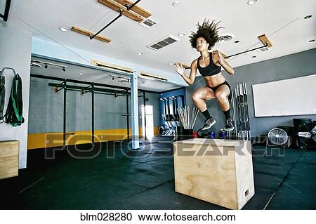 Mixed race woman working out in gym View Large Photo Image Stock Image - Mixed race woman working out in gym. Fotosearch