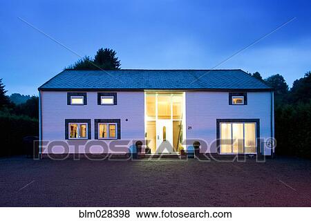 Modern house illuminated at twilight View Large Photo Image Stock Photo - Modern house illuminated at twilight. Fotosearch