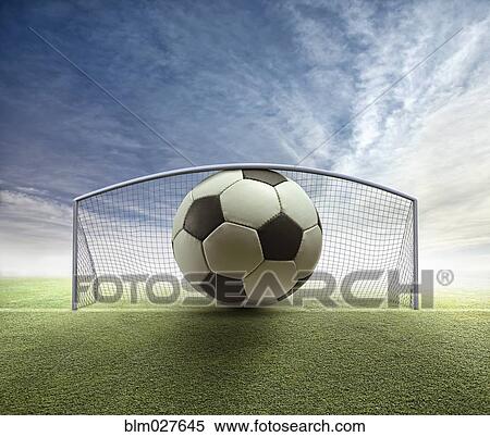 Stock Photography - Oversized soccer ball stuck in goal. Fotosearch