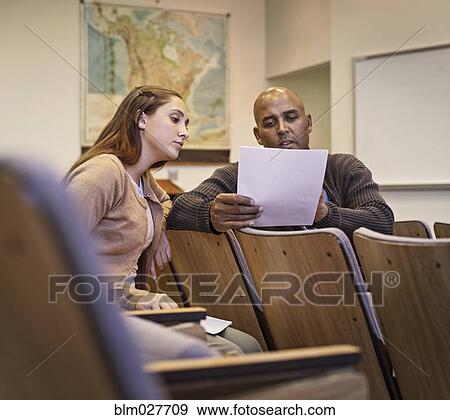 Professor and student reviewing essay in lecture hall View Large Photo Image Stock Photo - Professor and student reviewing essay in lecture hall. Fotosearch