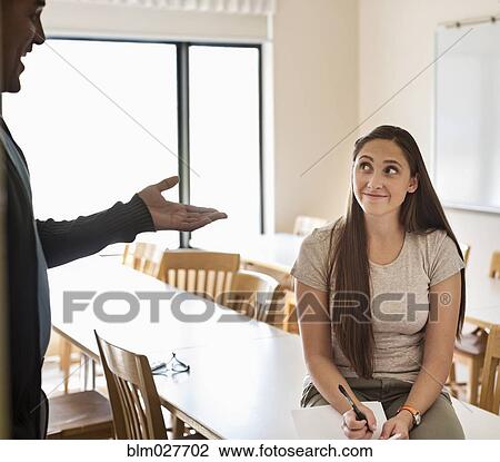 Professor and student talking in classroom View Large Photo Image Stock Image - Professor and student talking in classroom. Fotosearch