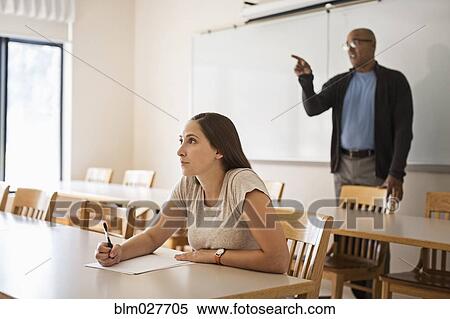 Stock Photography - Professor and student talking in classroom. Fotosearch