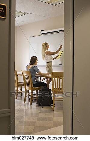 Stock Photo - Professor and student working in classroom. Fotosearch