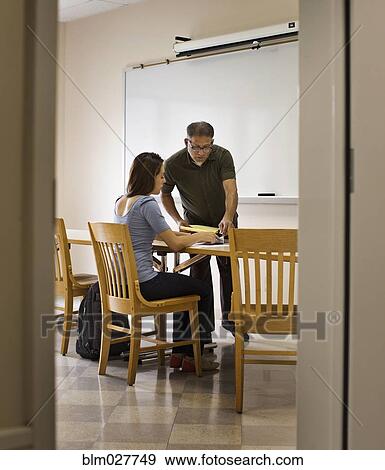 Stock Photo - Professor and student working in classroom. Fotosearch
