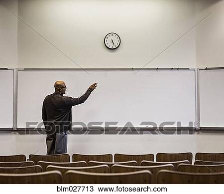 Professor standing in empty classroom View Large Photo Image Stock Image - Professor standing in empty classroom. Fotosearch