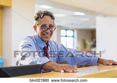 Senior man smiling in library View Large Photo Image Stock Image - Senior man smiling in library. Fotosearch