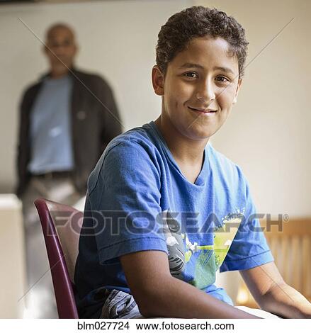 Picture - Student smiling in classroom. Fotosearch