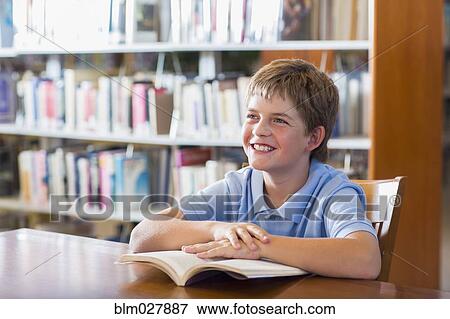 Stock Photo - Student smiling in library. Fotosearch