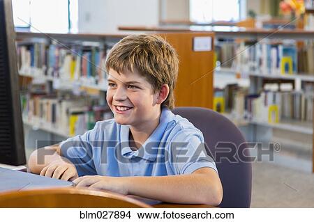 Student working at computer in library View Large Photo Image Picture - Student working at computer in library. Fotosearch