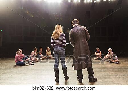 Stock Image - Students practicing lines on stage. Fotosearch
