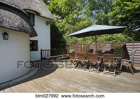 Table and chairs on cottage patio View Large Photo Image Stock Image - Table and chairs on cottage patio. Fotosearch