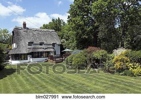 Thatched roof cottage View Large Photo Image Stock Image - Thatched roof cottage. Fotosearch