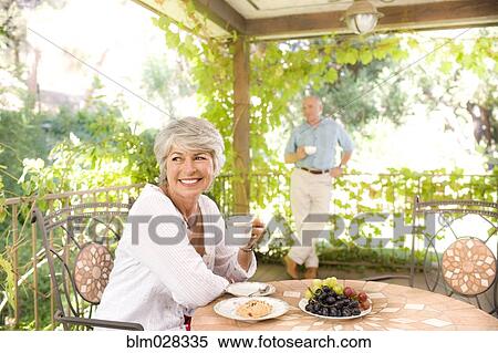 Woman having breakfast outdoors View Large Photo Image Stock Photography - Woman having breakfast outdoors. Fotosearch