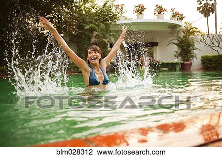 Woman playing in swimming pool View Large Photo Image Stock Image - Woman playing in swimming pool. Fotosearch