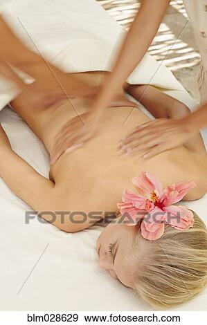 Stock Photo - Woman receiving massage in spa. Fotosearch