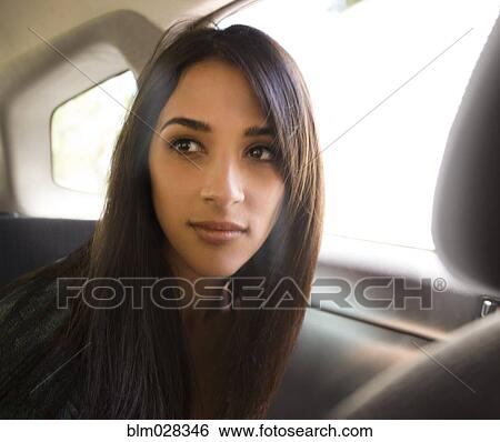 Woman sitting in back seat of car View Large Photo Image Stock Photograph - Woman sitting in back seat of car. Fotosearch