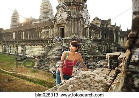 Woman visiting ancient temple, Angkor, Siem Reap, Cambodia View Large Photo Image Stock Image - Woman visiting ancient temple, Angkor, Siem Reap, Cambodia. Fotosearch