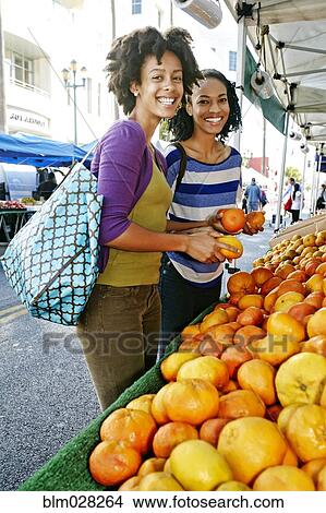 Women shopping together at fruit stand View Large Photo Image Picture - Women shopping together at fruit stand. Fotosearch
