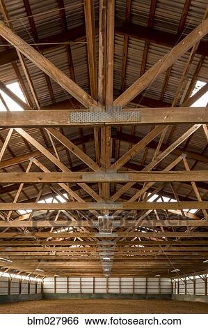 Wooden rafters in indoor horse riding ring View Large Photo Image Stock Photograph - Wooden rafters in indoor horse riding ring. Fotosearch