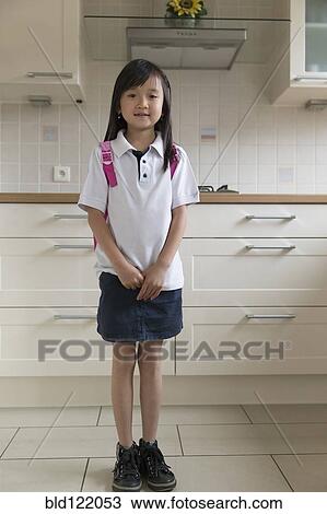 Asian girl smiling in kitchen View Large Photo Image Stock Image - Asian girl smiling in kitchen. Fotosearch