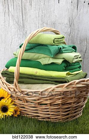Basket of folded green clothes in grass View Large Photo Image Stock Photo - Basket of folded green clothes in grass. Fotosearch