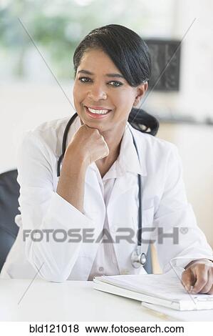 Stock Photo - Black doctor smiling in office. Fotosearch