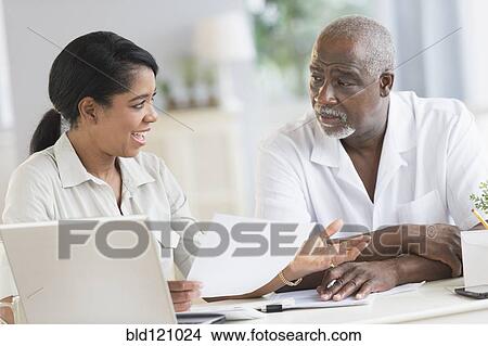 Picture - Black father and daughter using laptop. Fotosearch
