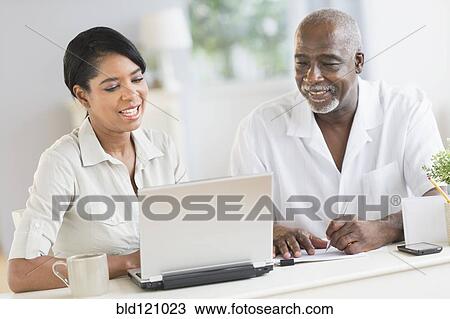 Black father and daughter using laptop View Large Photo Image Stock Image - Black father and daughter using laptop. Fotosearch