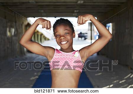 Black girl flexing muscles outdoors View Large Photo Image Stock Image - Black girl flexing muscles outdoors. Fotosearch