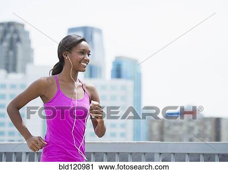 Black woman running on city street View Large Photo Image Stock Image - Black woman running on city street. Fotosearch