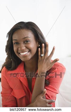 Black woman showing off engagement ring View Large Photo Image Stock Photo - Black woman showing off engagement ring. Fotosearch