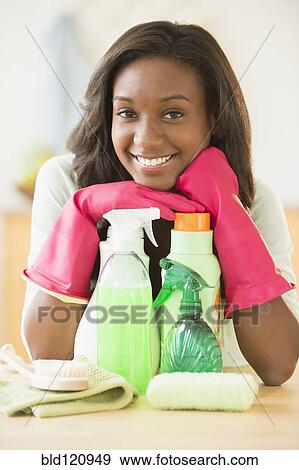 Black woman smiling with cleaning products View Large Photo Image Stock Photo - Black woman smiling with cleaning products. Fotosearch