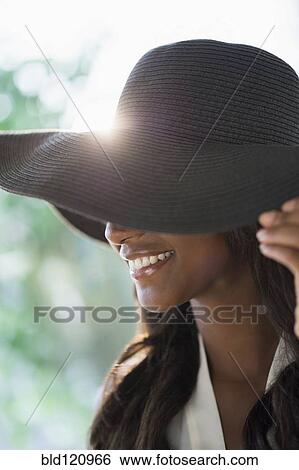 Black woman wearing sun hat View Large Photo Image Stock Photograph - Black woman wearing sun hat. Fotosearch