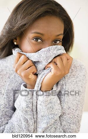 Picture - Black woman wearing warm sweater. Fotosearch