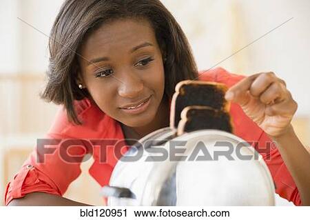 Stock Image - Black woman with burned toast. Fotosearch