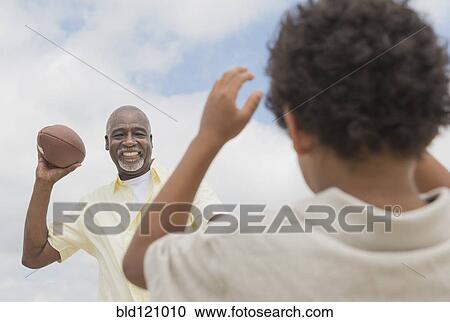 Boy playing catch with grandfather outdoors View Large Photo Image Stock Image - Boy playing catch with grandfather outdoors. Fotosearch